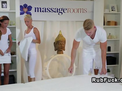 Couple giving massage to sexy brunette